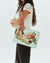 WOMAN HOLDING CONSUELA  POUCH CLUTCH 