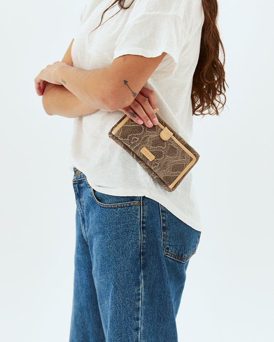 WOMAN HOLDING CONSUELA SLIM WALLET CALLED "DIZZY"